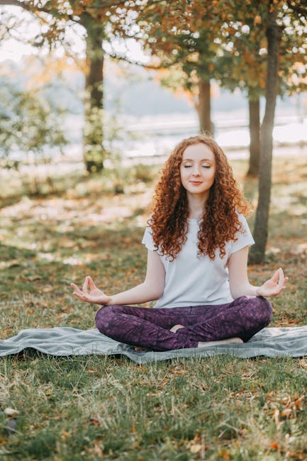 Woman practicing yoga outdoors in a calm natural setting